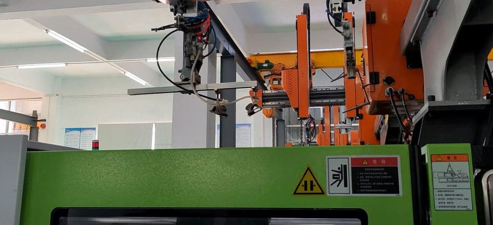 injection molding machine + robotic arm